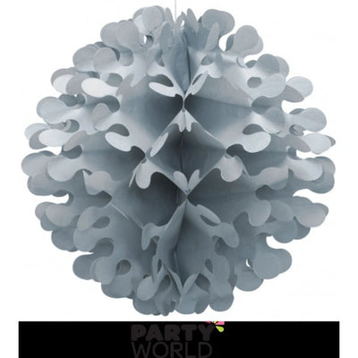 Lime green 30cm tissue flutter ball hanging as a bright decoration above a garden party