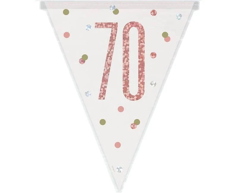 Rose gold and silver 70th birthday bunting strung above a milestone party table