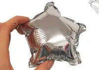 Mini silver star foil balloons, 12cm, pack of three, tucked into a balloon garland
